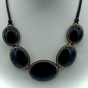 Vintage Black beads on leather corded.  Marked